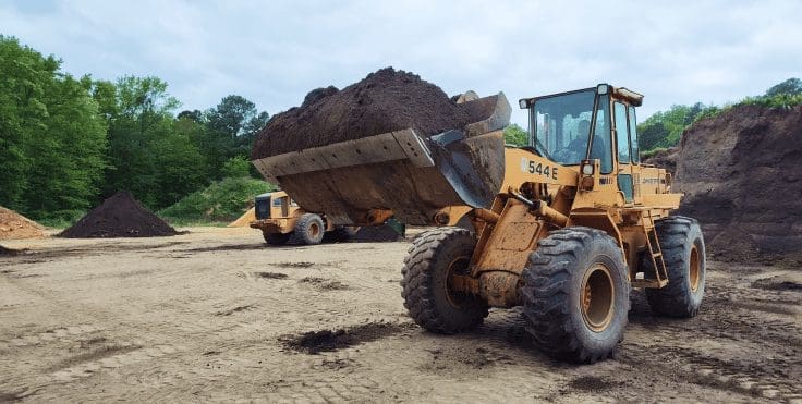 truck pulling soil